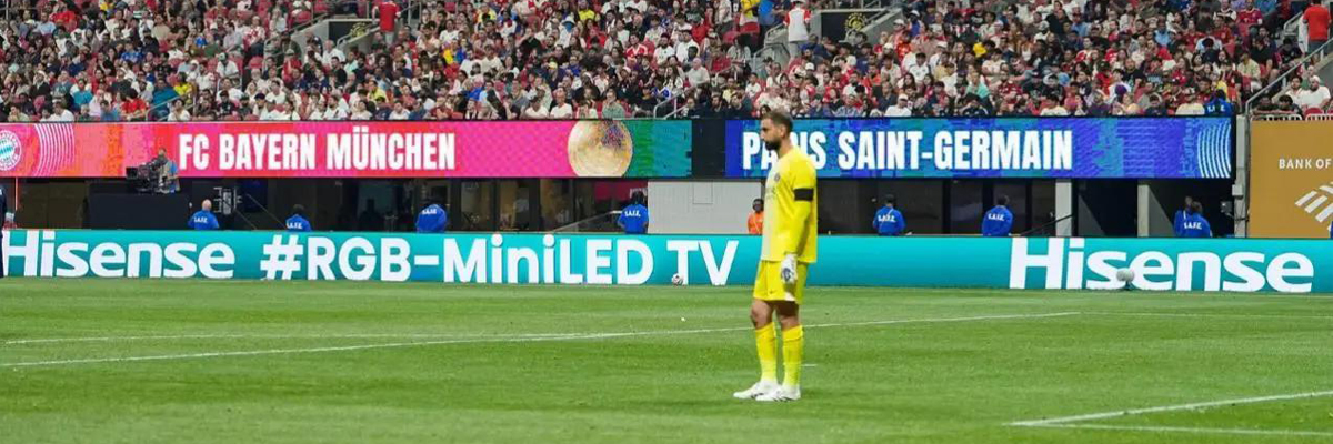 A wide shot of packed grandstands and a live football match in progress at a massive World Cup stadium filled with passionate fans.